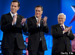 Republican presidential candidates Rick Santorum, Mitt Romney and Newt Gingrich applaud the arrival of Ron Paul to the debate hall on Feb. 22, 2012 in Mesa, Ariz. (DON EMMERT/AFP/Getty Images)