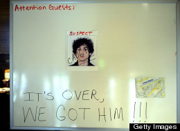 A sign in a Boston hotel lobby on April 20, 2013, shows a photo of Dzhokhar Tsarnaev the morning after he was captured. Thousands of heavily armed police staged an intense manhunt Friday for the 19-year-old suspected in the Boston Marathon bombings with his brother, who was killed in a shootout. (AFP PHOTO / TIMOT)