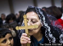 An Iraqi-Canadian kisses the cross during mass at the Our Lady of Good Counsel Church in Surrey December 12, 2010. New immigrants to Canada, many who look to their faith for comfort in a new country, are changing the country's religious makeup, according to data released from the 2011 National Household Survey. (John Lehmann/The Globe and Mail)