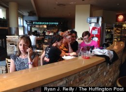 Medea Benjamin (left) of the anti-war activism group Code Pink fields media phone calls at a Starbucks after she interrupted President Barack Obama's major national security speech Thursday, May 23, 2013. (Ryan J. Reilly/The Huffington Post).