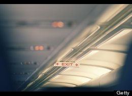 An illuminated cabin ceiling and exit sign of airplane are seen in this Getty photo. Airtran recently kicked more than 100 high school students off a flight because of rowdy behavior.
