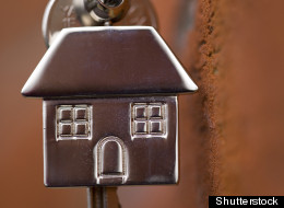 house keys hanging by a brick wall