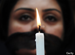 According to a new WHO report, one in three women experience sexual or physical violence. In this photograph, an Indian member of social organization Our City Our Right holds a candle during a silent protest following the recent gang rape and murder of a 20-year-old college student in Barasat, in Kolkata on June 15, 2013. Activists and social groups in various parts of the state held rallies and protests following the incident. (Image credit: AFP PHOTO/ Dibyangshu SARKAR/Getty Images)