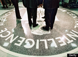 386984 06: President George W. Bush, Central Intelligence Agency Director George Tenet and others stand on the seal of the Agency March 20, 2001 at the CIA Headquarters in Langley, Virginia. Bush toured the facility and met some of the Agency''s employees. (Pool Photo by David Burnett/Newsmakers)