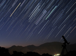 A bright meteor during Perseid meteor shower (Aug. 12 2012) is captured in a star trail image of constellation Orion