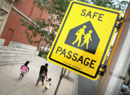 Students walk along a designated Safe Passage route to Laura Ward Elementary School on the West Side on August 28, 2013 in Chicago.
