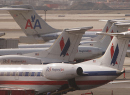 An American Airlines jet taxis past American Eagle jets at O'Hare Airport March 26, 2008 in Chicago, Illinois. (Photo by Scott Olson/Getty Images)