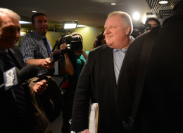TORONTO, ON - NOVEMBER 13 - Mayor Rob Ford's surrounded by media leaves his office with security and lawyer Dennis Morris at City Hall in Toronto on November 13, 2013 (Vince Talotta/Toronto Star via Getty Images)