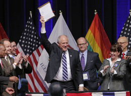 Illinois Gov. Pat Quinn acknowledges the applause after signing the Religious Freedom and Marriage Fairness Act into law, making Illinois the 16th state in the nation to embrace full marriage equality for same sex couples, Wednesday, Nov. 20, 2013, in Chicago. The law takes effect June 1, 2014. (AP Photo/M. Spencer Green)