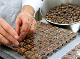 Pascal Caffet, awarded 'Meilleur Ouvrier de France' (best craftsman of France) in the category pastrymaking, chocolate maker of French gourmet food company Fauchon prepares hazelnut chocolates, on October 28, 2011 at Caffet's workshop in Troyes, eastern France, as he supervises the baking of almonds . The title 'Meilleur Ouvrier de France' is a unique award in France according to category of trades in a contest between professionals. AFP PHOTO FRANCOIS NASCIMBENI (Photo credit should read FRANCO