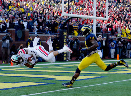 Wide receiver Devin Smith #9 of the Ohio State Buckeyes scores a touchdown in the first quarter as safety Josh Furman #14 of the Michigan Wolverines defends during a game at Michigan Stadium on November 30, 2013 in Ann Arbor, Michigan. (Photo by Gregory Shamus/Getty Images)