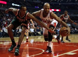 The Chicago Bulls' Taj Gibson controls the ball as the Milwaukee Bucks' John Henson, left, reaches in during the first quarter at United Center in Chicago on Tuesday, Dec. 10, 2013. (Scott Strazzante/Chicago Tribune/MCT via Getty Images)
