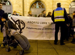 Women hold a banner reading 'Free and safe abortion' during a pro-choice demonstration against the government's plan to tighten abortion laws in Burgos on December 20, 2013. Pro-choice groups and political opponents called for nationwide protests as the government approved today a tightening of the abortion law that would end women's right to opt for the procedure freely up to 14 weeks of pregnancy rolling back on the previous Socialist government's 2010 reform. Pro-choice campaigners say the re