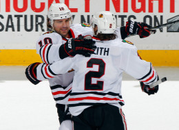 Patrick Sharp #10 of the Chicago Blackhawks is congratulated by Duncan Keith after Sharp scored his third goal of the game for a hat trick against the New Jersey Devils during the game at the Prudential Center on January 3, 2014 in Newark, New Jersey. The Blackhawks defeated the Devils 5-3. (Photo by Andy Marlin/NHLI via Getty Images)