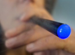 This September 25, 2013 photo illustration taken in Washington, DC, shows a woman smoking a 'Blu' e-cigarette (electronical cigarette). The National Association of Attorneys General on September 24, issued a letter urging the US Food and Drug Administration to clamp down on the fast-growing e-cigarette market, saying manufacturers are enticing teenagers to smoke with cartoon characters, television ads and bubble-gum flavors. (PAUL J. RICHARDS/AFP/Getty Images)