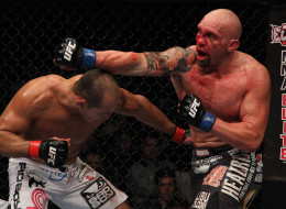 Shane Carwin punches Junior Dos Santos during a heavyweight bout at UFC 131 at Rogers Arena on June 11, 2011 in Vancouver. UFC is returning to Vancouver on June 14.