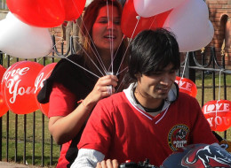 A Pakistani woman holds up heart-shaped balloons as the rides on a motorcycle on Valentine's Day in Lahore on February 14, 2012. (Arif Ali/AFP/Getty Images)