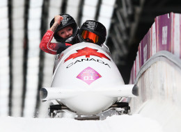 Kaillie Humphries (front) and Heather Moyse of Canada team 1 celebrate winning the gold medal during the Women's Bobsleigh on Day 12 of the Sochi 2014 Winter Olympics at Sliding Center Sanki on February 19, 2014 in Sochi, Russia. (Photo by Alex Livesey/Getty Images)