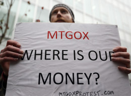 Kolin Burges, a Mt. Gox customer, holds a placard in front of a building housing the company operating the Mt. Gox Bitcoin exchange in Tokyo, Japan, on Thursday, Feb. 27, 2014. The Bitcoin Foundation, an advocacy group for the nascent digital currency, provided information to federal prosecutors this week that aided a probe into Mt. Gox, a shuttered exchange in Tokyo. Photographer: Tomohiro Ohsumi/Bloomberg via Getty Images