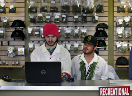 Employees David Marlow, right, and Chris Broussard work behind sales counter inside Medicine Man marijuana retail store, which opened as a legal recreational retail outlet in Denver on Wednesday Jan. 1, 2014. Colorado began retail marijuana sales on Jan. 1, a day some are calling