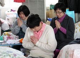KAZO, JAPAN - MARCH 11: (JAPANESE NEWSPAPERS OUT) Evacuees from Futaba Town, inside the exclusion zone of the Fukushima Daiichi Nuclear Power Plant observe a nimute of silense at 2:46pm, for the earthquake and tsunami victims at the evacuation center on March 11, 2012 in Kazo, Saitama, Japan. On the one year anniversary, the areas most affected by last year's March 11, 2011 earthquake and subsequent tsunami that left 15,854 dead and 3,155 missing continue to struggle and more than 340,000 peopl