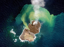 This is a satellite image of the volcanic activity from Nishinoshima (Ogasawara) island collected on December 31st, 2013. This image shows a new island, provisionally named Niijima, merging with Nishinoshima.