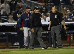 John Farrell #53 of the Boston Red Sox reacts after being ejected by umpire Bob Davidson #61 arguing a call settled by instant replay during a game against the New York Yankees at Yankee Stadium on April 13, 2014 in the Bronx Borough of New York City. Home plate umpire Brian O'Nora looks on. (Photo by Jeff Zelevansky/Getty Images)