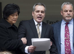 Douglas de Grood, centre, is supported by wife Susan, left, and lawyer Allan Fay after reading a statement in Calgary, Alberta on Thursday, April 17, 2014. De Grood's son Mathew is charged with killing five young people in Calgary. (THE CANADIAN PRESS/Larry MacDougal)