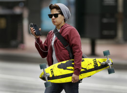A woman uses a cellphone in downtown San Francisco Wednesday, June 5, 2013. San Francisco's district attorney and New York's attorney general say they will meet with major cell phone manufacturers, as they push the industry to do more to protect consumers from violent street crimes connected to cell phone thefts. (AP Photo/Ben Margot)