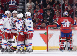 Ryan McDonagh #27 of the New York Rangers celebrates with teammates Martin St. Louis #26, Brad Richards #19 and Chris Kreider #20 after scoring a goal on goaltender Peter Budaj #30 the Montreal Canadiens in Game One of the Eastern Conference Final during the 2014 Stanley Cup Playoffs at the Bell Centre on May 17, 2014 in Montreal, Quebec, Canada. (Photo by Francois Lacasse/NHLI via Getty Images)