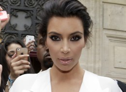 American reality TV star Kim Kardashian leaves her residence in Paris on May 23, 2014, ahead of their wedding. American singer Kanye West and his bride-to-be Kim Kardashian lunched on May 23 at a French chateau owned by iconic designer Valentino, kicking off a marathon celebration expected to culminate in the wedding of the year. AFP PHOTO / KENZO TRIBOUILLARD (Photo credit should read KENZO TRIBOUILLARD/AFP/Getty Images)