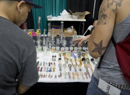 Attendees look at marijuana paraphenelia displays at the HempCon medical marijuana show, May 24, 2013. (Photo credit should read ROBYN BECK/AFP/Getty Images)