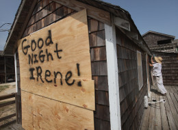 Fen Rascoe boards up his parent's cottage as they prepare for Hurricane Irene August 25, 2011 in Nags Head, North Carolina. (Photo by Scott Olson/Getty Images)