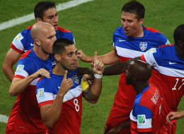 Clint Dempsey of the United States celebrates with teammates after scoring his team's first goal during the 2014 FIFA World Cup Brazil Group G match between Ghana and the United States at Estadio das Dunas on June 16, 2014 in Natal, Brazil. (Photo by Laurence Griffiths/Getty Images)
