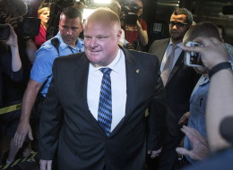 Toronto Mayor Rob Ford is greeted by a media throng as returns to his office at city hall in Toronto on Monday June 30, 2014, after his stay in a rehabilitation facility. THE CANADIAN PRESS/Chris Young