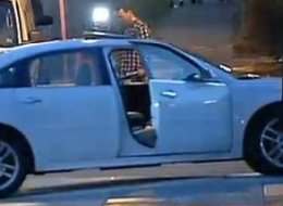 Investigators look for evidence in the car where a woman was shot to death in Philadelphia on Wednesday morning.