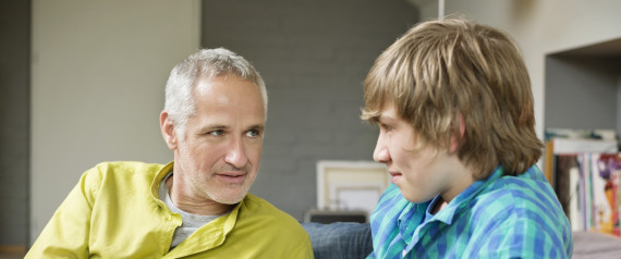 MAN TALKING TO TEENAGER