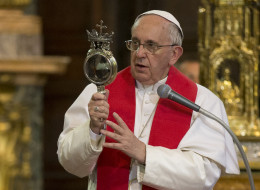 Pope Francis holds a relic believed to contain the blood of St. Gennaro. He's credited with a 'half-miracle' after the blood 'half-liquified' in his presence. (Andrew Medichini/AP)