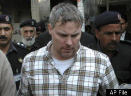 In this Friday, Jan. 28, 2011, photo, Pakistani security officials escort a U.S. consulate employee, identified as Raymond Davis, to a local court in Lahore, Pakistan. Colorado authorities say Davis, accused of shooting and killing two men while working as CIA contractor in Pakistan, faces misdemeanor charges after a fight Saturday, Oct. 1, 2011, over a shopping center parking spot in Highlands Ranch, Colo. In February, Davis shot two Pakistani men he said tried to rob him. Pakistan released him