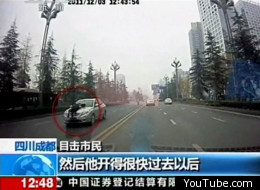 A Chinese policeman clung onto the bonnet of an illegal taxi at speeds of over 90mph as the driver tried to escape