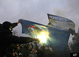 Protesters burn a United Russia party flag during a mass rally to protest against alleged vote rigging in Russia's parliamentary elections in Moscow, Russia, Saturday, Dec. 10, 2011. ( AP Photo/Sergey Ponomarev)