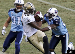 New Orleans Saints wide receiver Marques Colston (12) scores his second touchdown of the game on a 28-yard pass play as he is defended by Tennessee Titans cornerback Cortland Finnegan (31) and cornerback Alterraun Verner (20) in the fourth quarter of an NFL football game on Sunday, Dec. 11, 2011, in Nashville, Tenn. The Saints won 22-17. (AP Photo/Joe Howell)