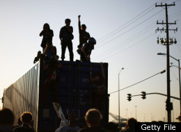 Demonstrators with the Occupy movement stand on a truck at the Port of Oakland November 2, 2011 in Oakland, California. (Photo by Eric Thayer/Getty Images)