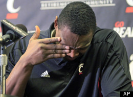 Cincinnati forward Yancy Gates wipes tears from his eyes, Monday, Dec. 12, 2011, at a news conference in Cincinnati where he apologized for his part in a fight that broke out at the end of an NCAA college basketball game between Cincinnati and Xavier, on Saturday. (AP Photo/Al Behrman)
