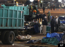 A sanitation worker removes debris from the Occupy Baltimore site after police evicted occupiers from McKeldin Square in Baltimore, Tuesday, Dec. 13, 2011. Baltimore City police moved into McKeldin Square around 3:30 a.m. and closed off surrounding streets.