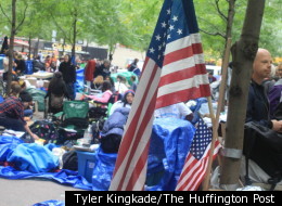 A flag taped to a tree in Zuccotti Park hangs amid Occupy Wall Street protesters, prior to their eviction from the park.