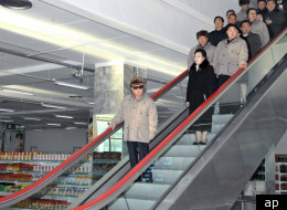 In this undated photo released by the Korean Central News Agency and distributed in Tokyo by the Korea News Service on Saturday, Dec. 17, 2011, North Korean leader Kim Jong Il, left, rides an escalator as he visits a Pyongyang supermarket. (AP)