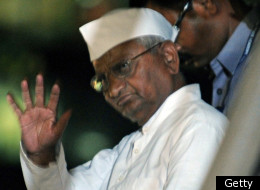 Indian social activist Anna Hazare gestures as he leaves the venue after breaking his fast at the Mumbai Metropolitan Region Development Authority (MMRDA) recreation ground in Mumbai on December 28, 2011. (Getty)