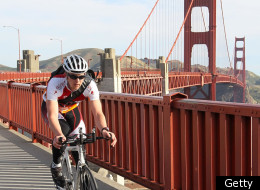 A cyclists rides across the Golden Gate Bridge.