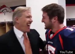 John Elway congratulates Tim Tebow durinf the Broncos' locker room celebration.